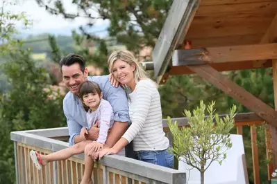 family on the deck of a cabin