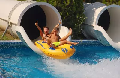 people at the end of a water slide