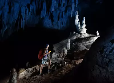 woman walking in a cave