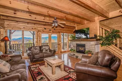 living room with stone fireplace and mountain view at Starry Mountain Moonlight