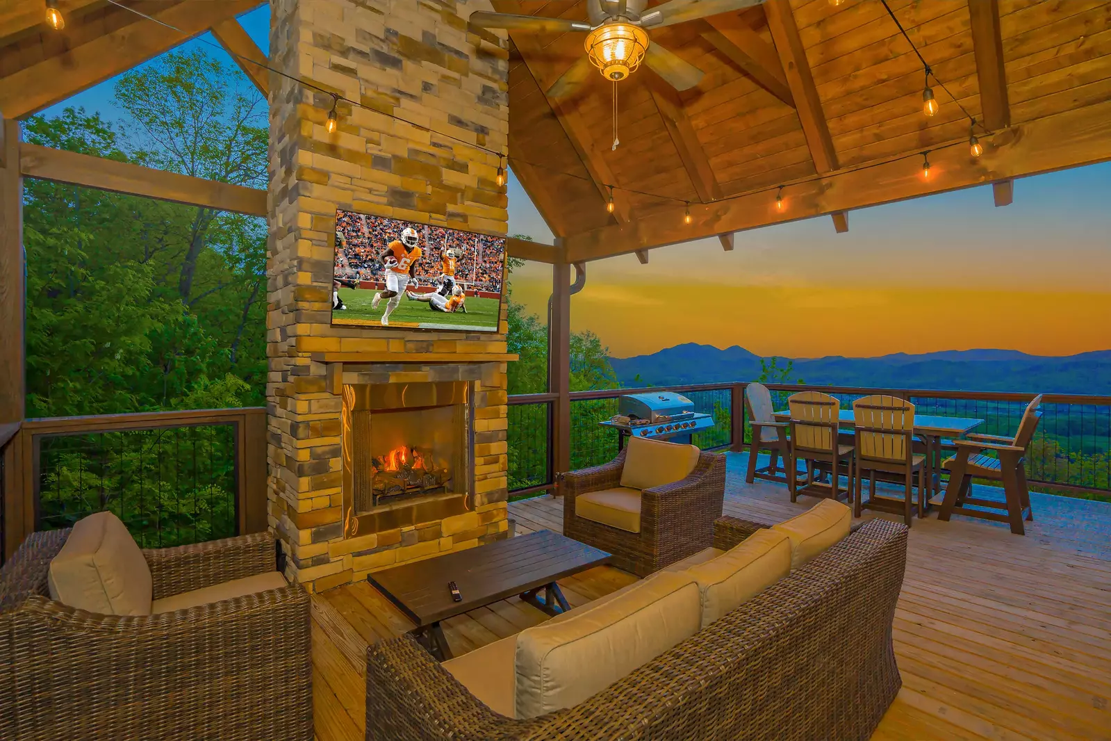 Cliffside Scenic Splendor cabin deck with outdoor fireplace and mountain view