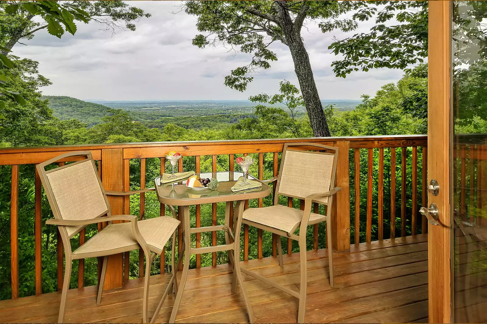 chairs and table on deck of Afterglow cabin with mountain view